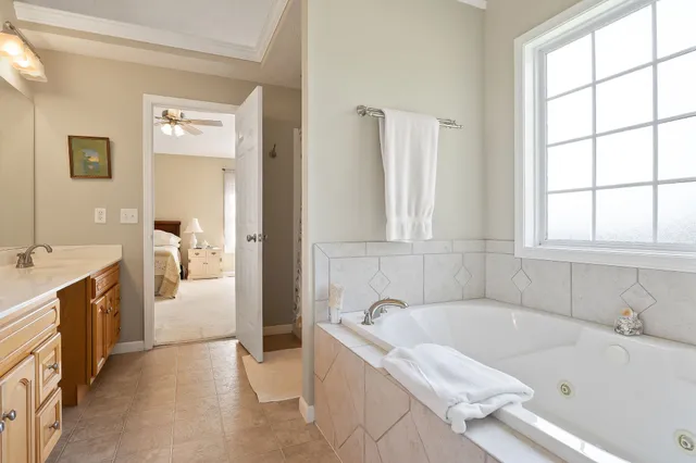 a white bath tub sitting next to a bathroom sink