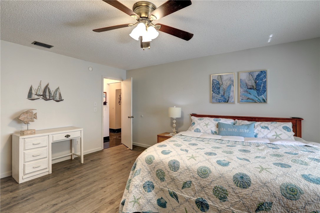8205 Capewell Court Sebastian, FL 32958 - Photo 11 of 25 a bedroom with a large bed and a chandelier