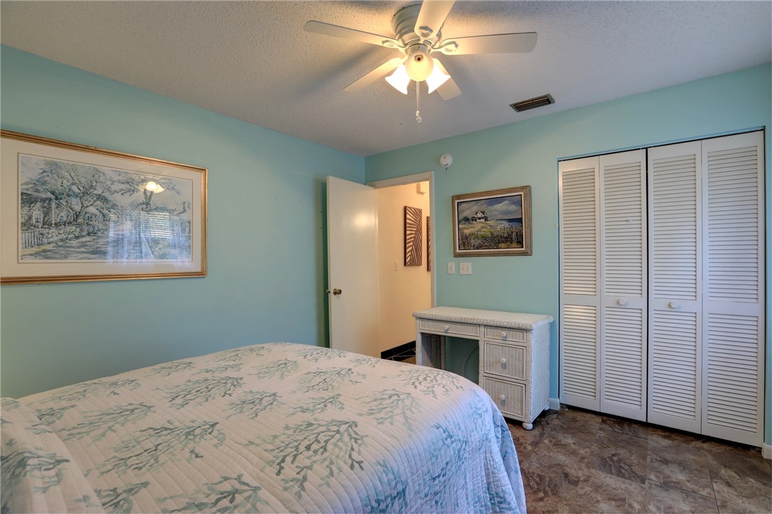 8205 Capewell Court Sebastian, FL 32958 - Photo 14 of 25 a bedroom with a large bed and a chandelier