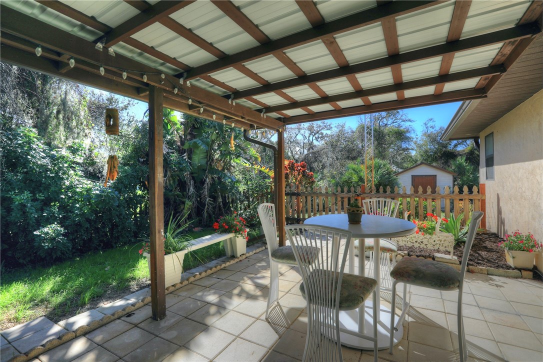 8205 Capewell Court Sebastian, FL 32958 - Photo 16 of 25 a patio with yard table and chairs