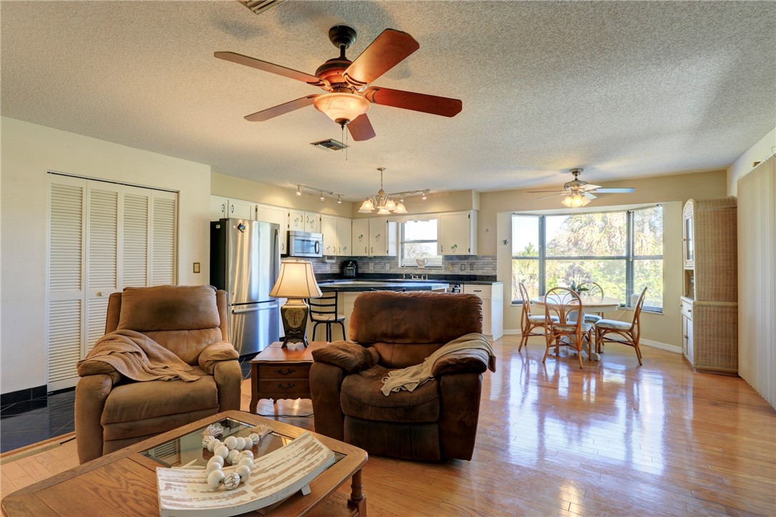 8205 Capewell Court Sebastian, FL 32958 - Photo 6 of 25 a living room with furniture kitchen view and a large window