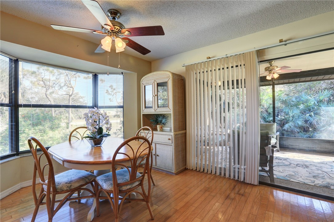 8205 Capewell Court Sebastian, FL 32958 - Photo 7 of 25 a dining room with furniture a chandelier and wooden floor