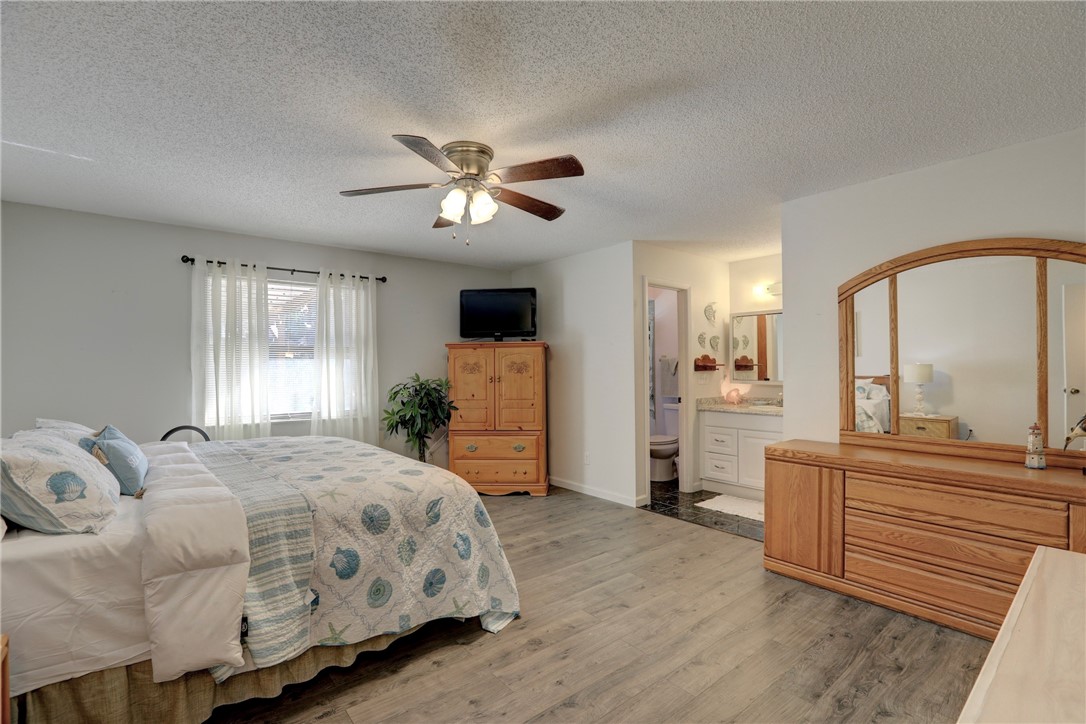 8205 Capewell Court Sebastian, FL 32958 - Photo 10 of 25 a bedroom with a large bed and a chandelier