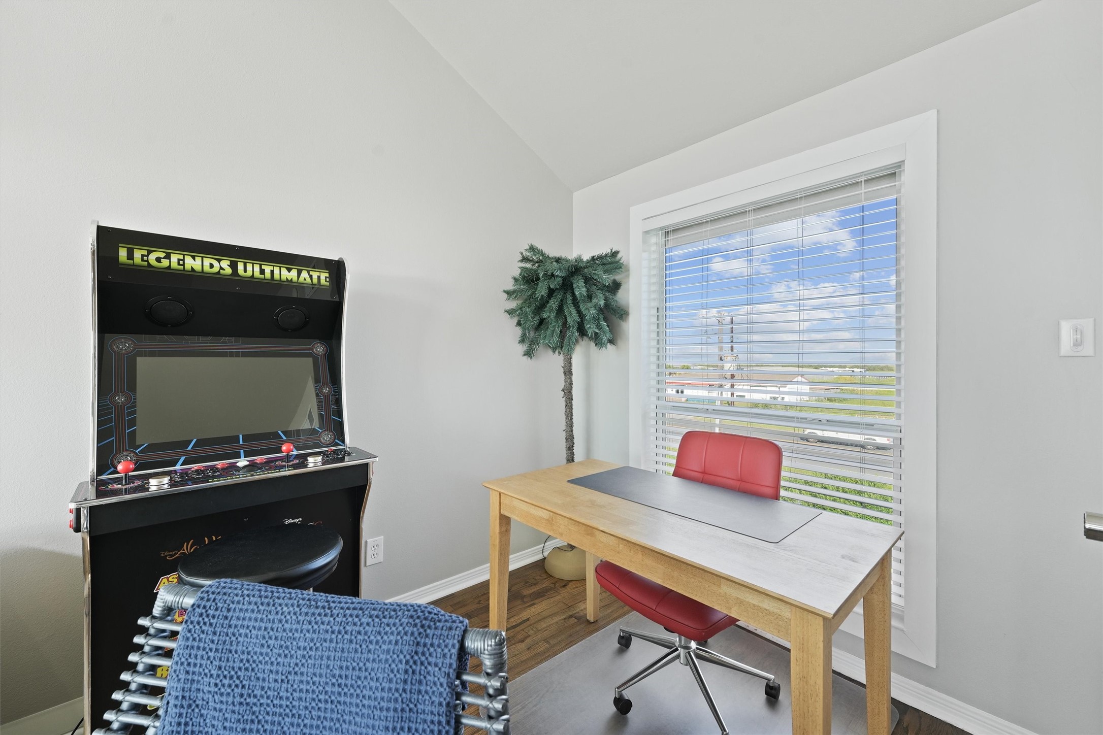 17607 Termini-San Luis Pass Road Galveston, TX 77554 - Photo 10 of 42 This cozy office nook is located within the living room, offering a bright and comfortable workspace with a view. The home comes fully furnished, complete with unique touches like the retro arcade game for fun breaks in between work sessions.