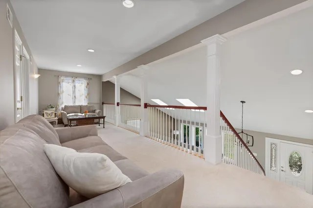 a living room with furniture and stairs