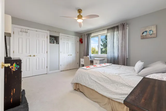 a spacious bedroom with a bed and a chandelier