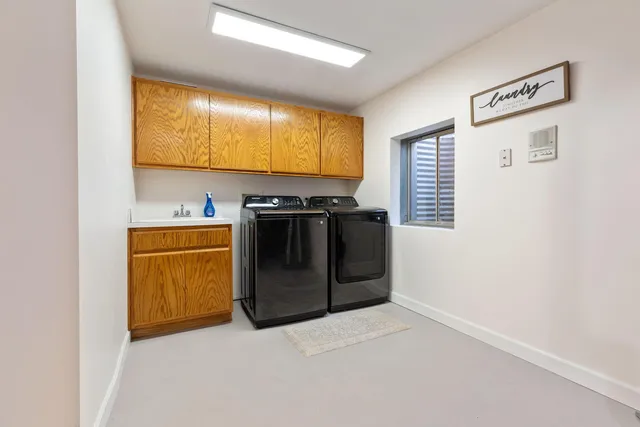 a kitchen with stainless steel appliances granite countertop a stove a sink and a refrigerator with wooden floor