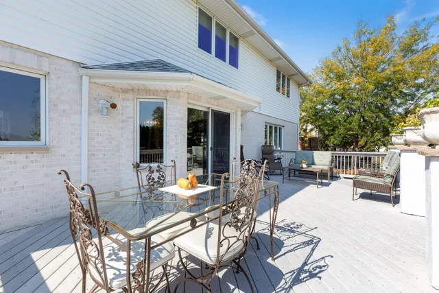 a view of a patio with table and chairs and potted plants