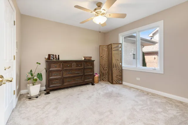 a view of an empty room with a window and cabinet