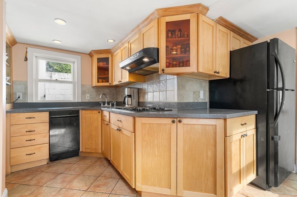 12 Spring Street Newton, MA 02464 - Photo 11 of 42 a kitchen with stainless steel appliances granite countertop a refrigerator and a stove top oven