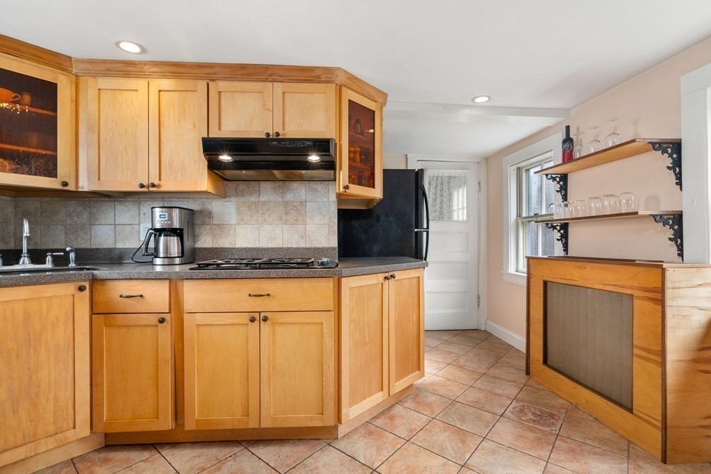 12 Spring Street Newton, MA 02464 - Photo 12 of 42 a kitchen with stainless steel appliances granite countertop a refrigerator and microwave