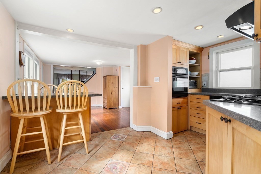 12 Spring Street Newton, MA 02464 - Photo 15 of 42 a kitchen with granite countertop cabinets and steel stainless steel appliances