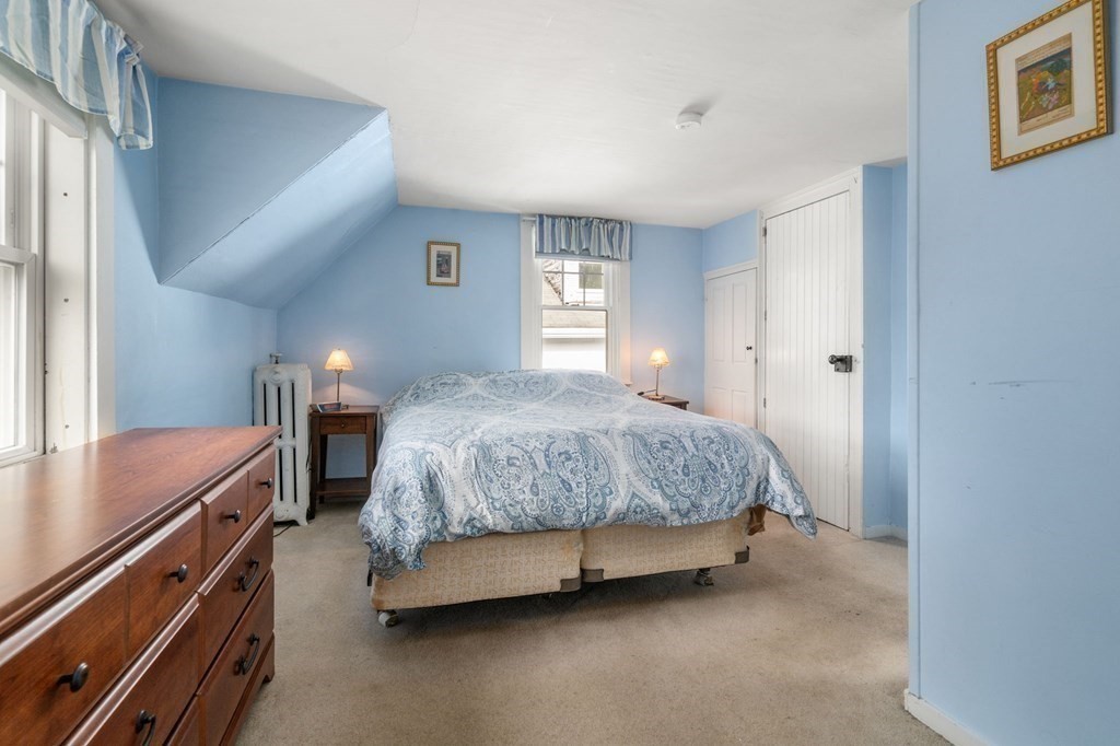 12 Spring Street Newton, MA 02464 - Photo 30 of 42 a bedroom with a bed and a night stand