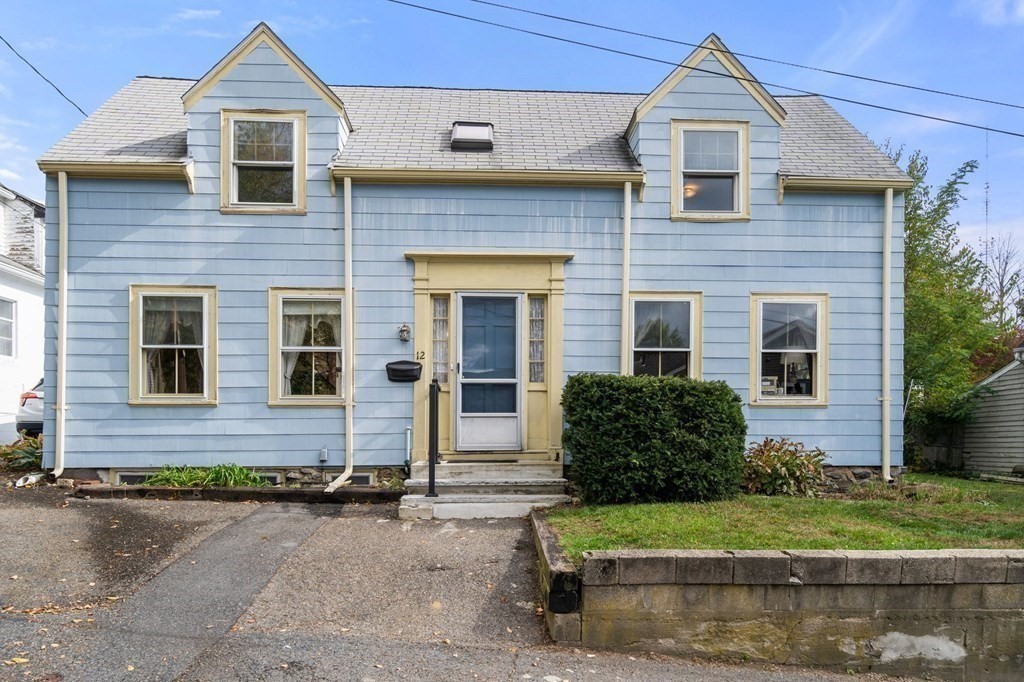 12 Spring Street Newton, MA 02464 - Photo 3 of 42 a front view of a house with a yard and garage