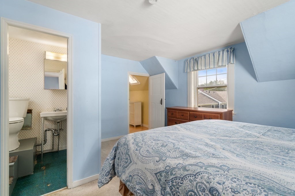 12 Spring Street Newton, MA 02464 - Photo 31 of 42 a bedroom with a bed and a window