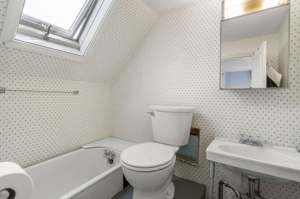 12 Spring Street Newton, MA 02464 - Photo 32 of 42 a white toilet sitting next to a white sink