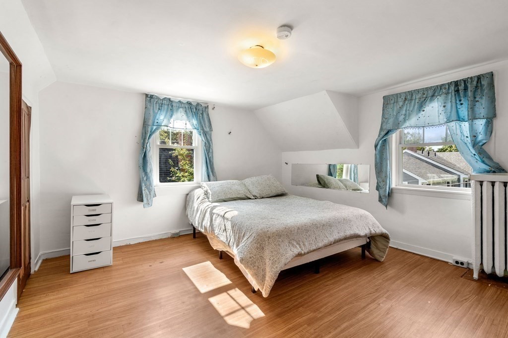 12 Spring Street Newton, MA 02464 - Photo 34 of 42 a bedroom with a bed dresser and a window
