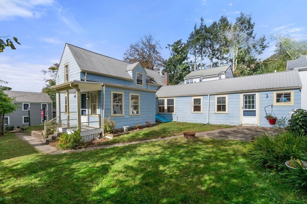 12 Spring Street Newton, MA 02464 - Photo 38 of 42 a view of a yard in front of a house with plants and large tree