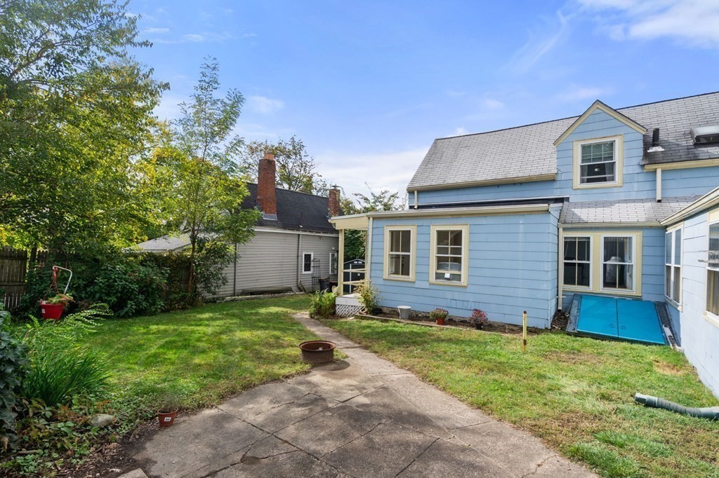 12 Spring Street Newton, MA 02464 - Photo 40 of 42 a view of a yard in front of a house with plants and large tree