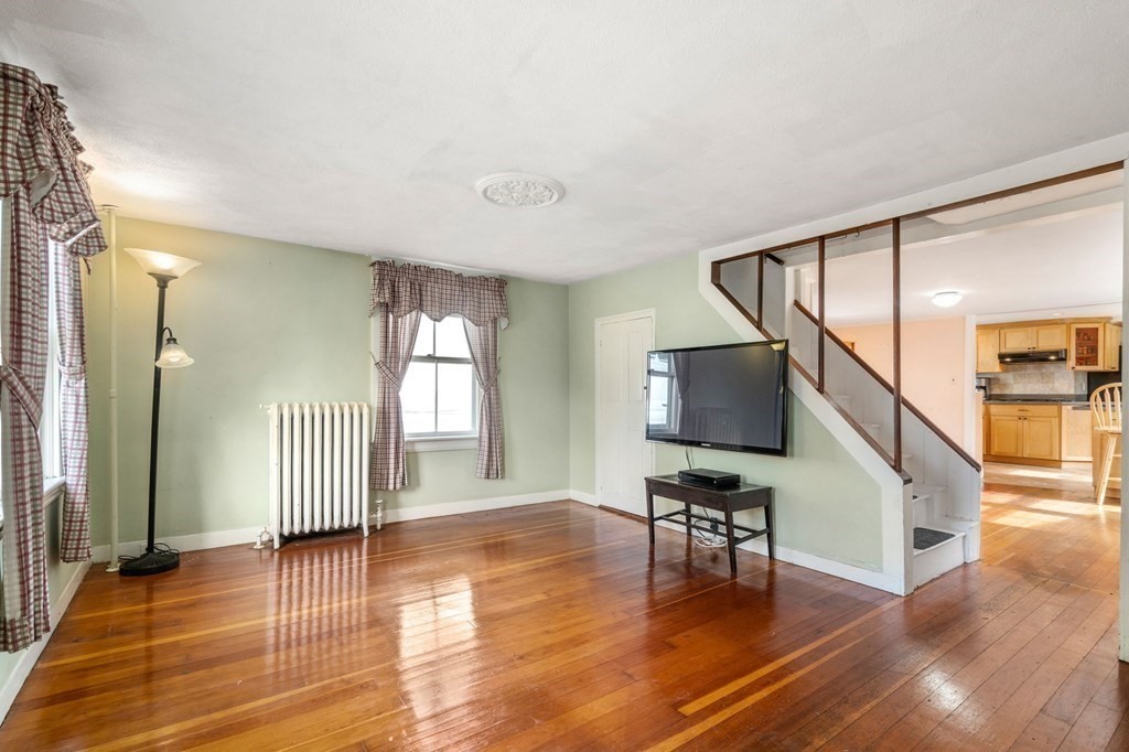 12 Spring Street Newton, MA 02464 - Photo 4 of 42 a hallway with wooden floor and furniture