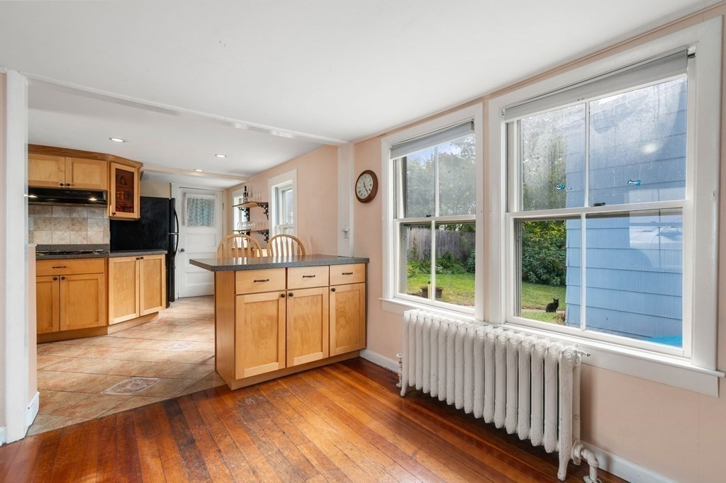 12 Spring Street Newton, MA 02464 - Photo 9 of 42 a view of a kitchen with a sink cabinets and a living room