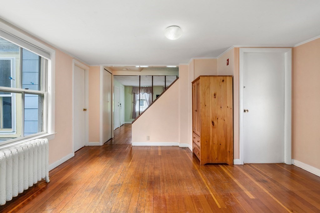 12 Spring Street Newton, MA 02464 - Photo 10 of 42 a view of hallway with stairs and wooden floor