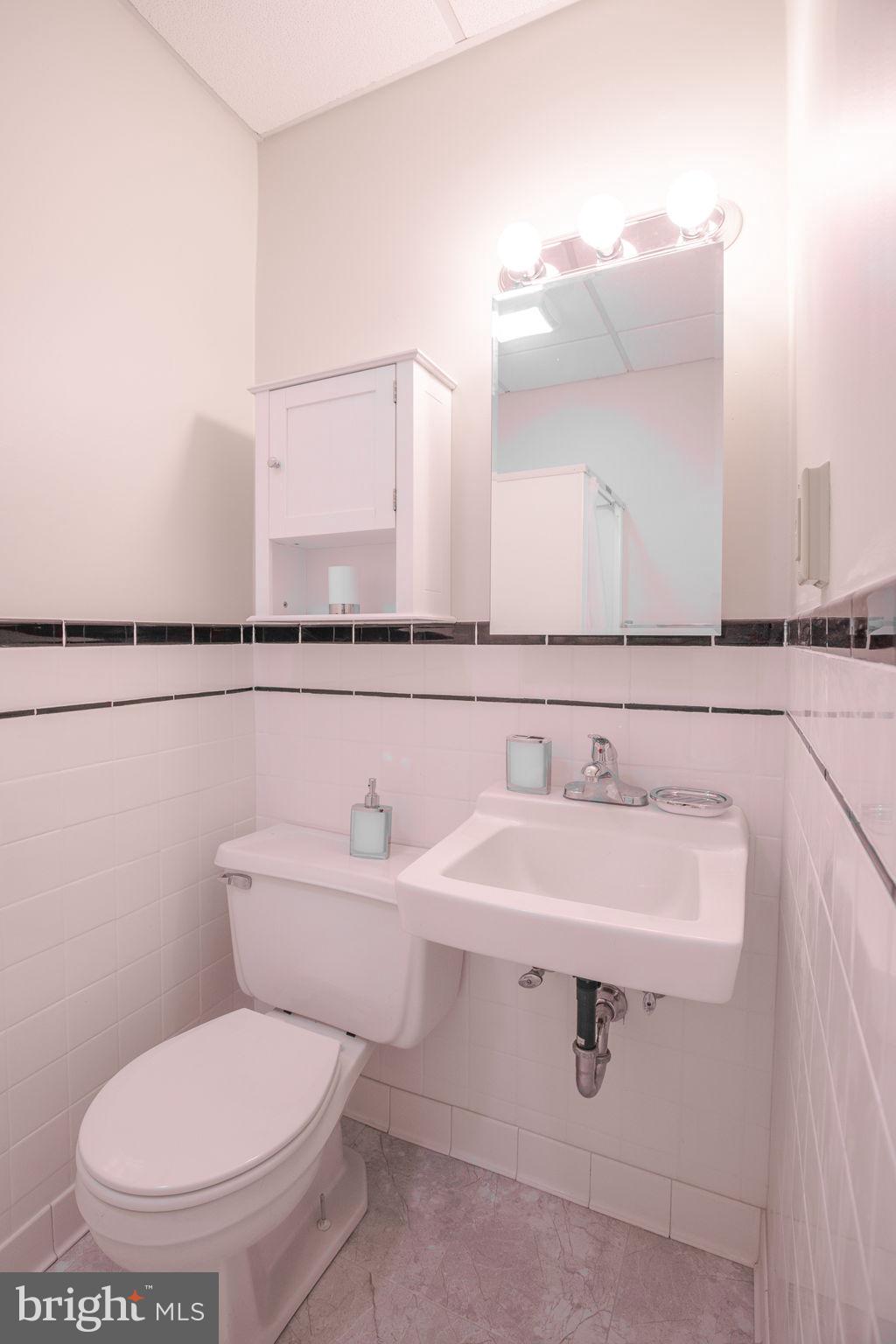 109 North Lime Street, Unit 2 Lancaster, PA 17602 - Photo 21 of 22 a bathroom with a toilet sink and mirror