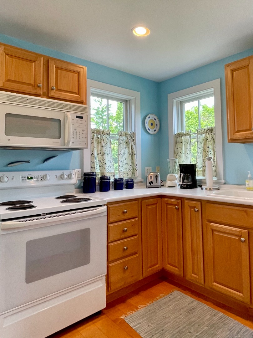 155 Surfside Road Nantucket, MA 02554 - Photo 42 of 60 a kitchen with granite countertop a sink stainless steel appliances and cabinets