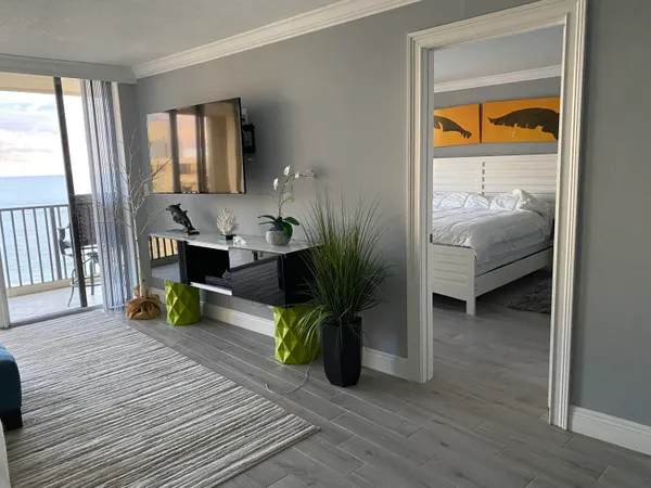 a living room with furniture and a wooden floor