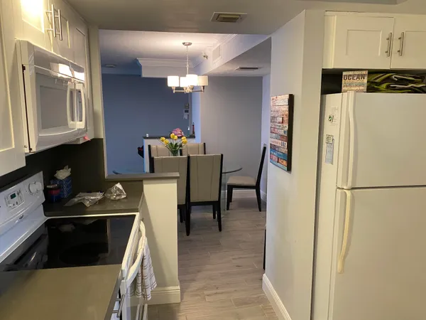 a kitchen with stainless steel appliances a refrigerator and a stove top oven