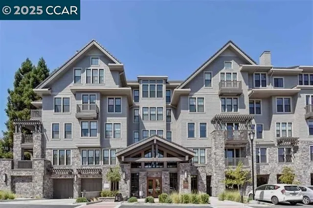 a front view of a residential apartment building with a yard