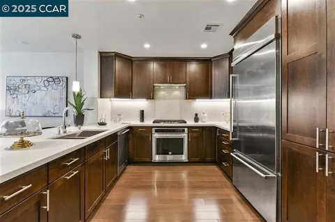a large kitchen with a stove and refrigerator