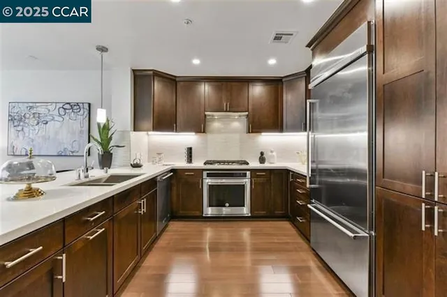 a large kitchen with a stove and refrigerator