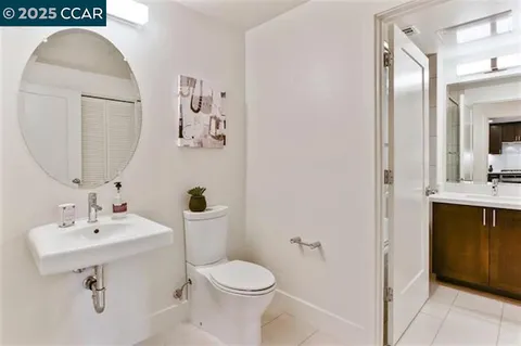 a bathroom with a sink toilet and mirror
