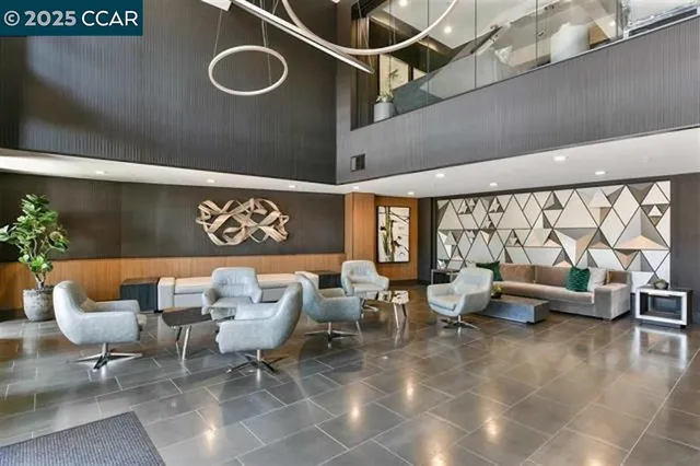 a living room with furniture and a floor to ceiling window