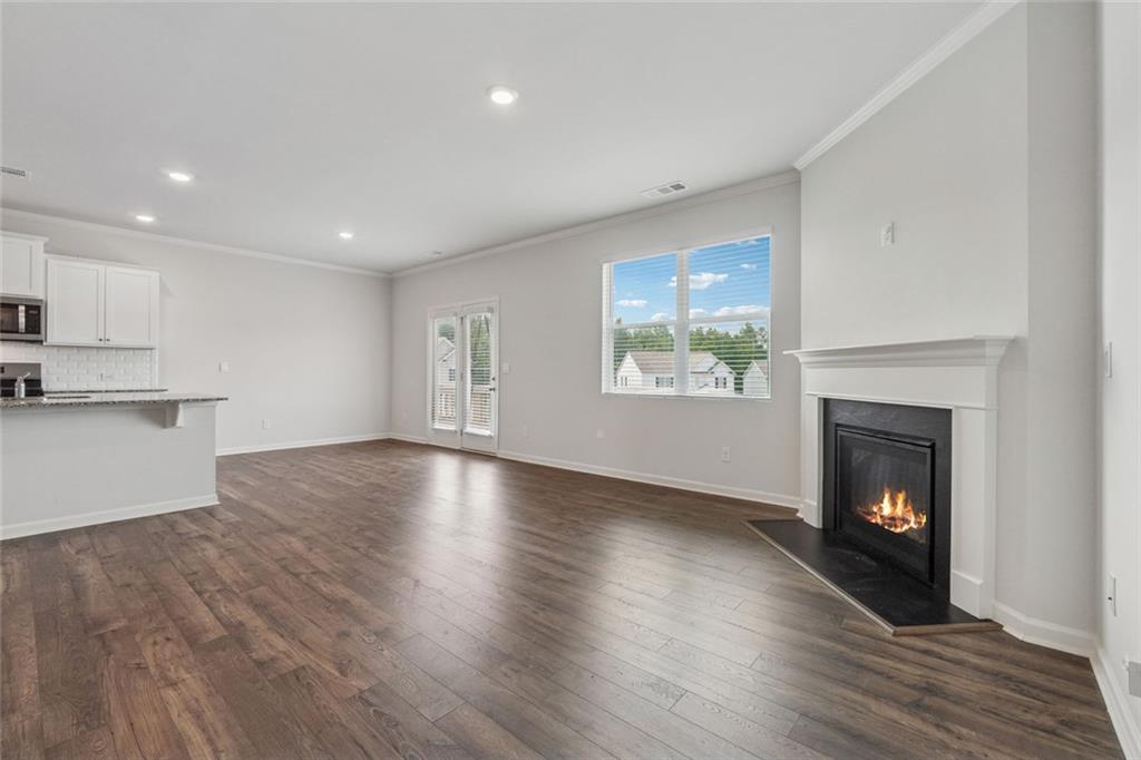 96 Quail Bend Way Dallas, GA 30157 - Photo 12 of 57 a view of an empty room with a fireplace and a window