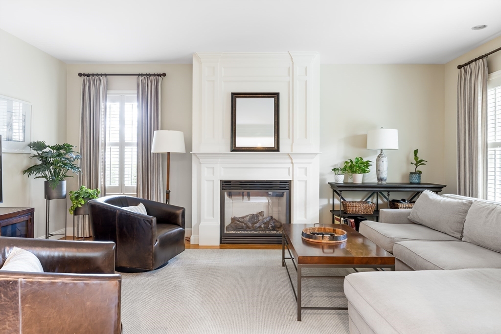 80 Emerson Road Needham, MA 02492 - Photo 11 of 41 a living room with furniture and a fireplace