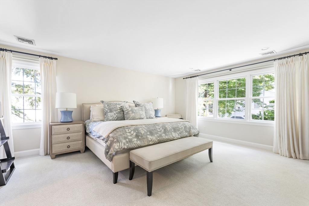 80 Emerson Road Needham, MA 02492 - Photo 18 of 41 a spacious bedroom with a bed and a large window