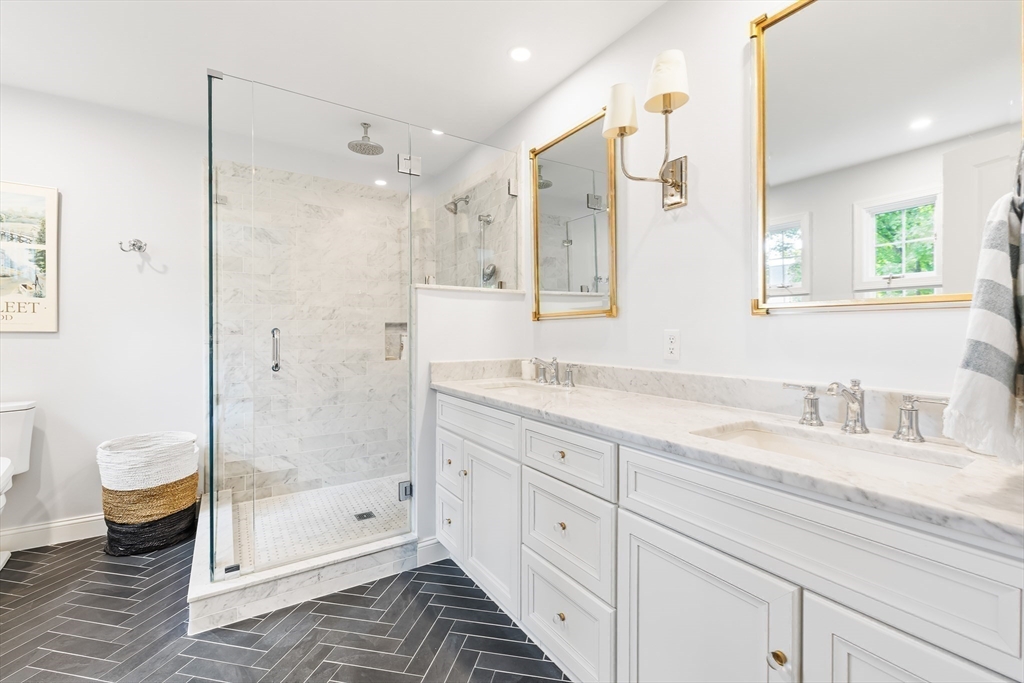 80 Emerson Road Needham, MA 02492 - Photo 20 of 41 a bathroom with a shower sink vanity and toilet