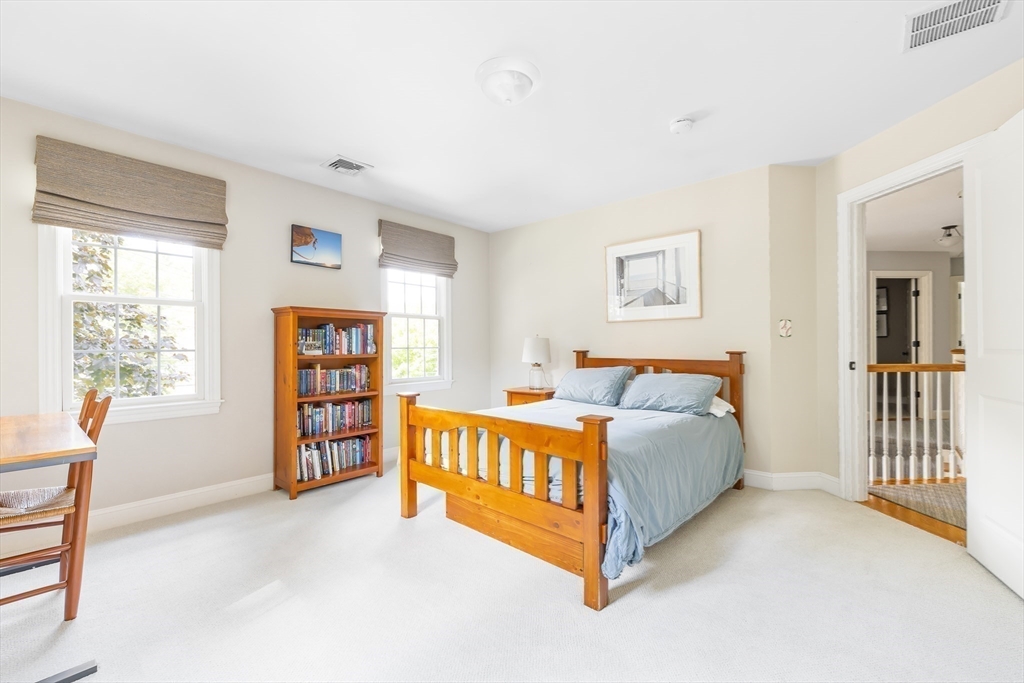 80 Emerson Road Needham, MA 02492 - Photo 25 of 41 a spacious bedroom with a bed and a window