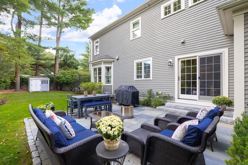 80 Emerson Road Needham, MA 02492 - Photo 33 of 41 a view of a patio with couches chairs and a yard
