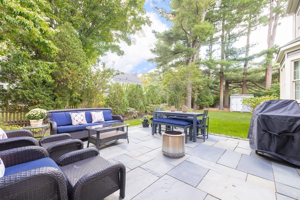 80 Emerson Road Needham, MA 02492 - Photo 34 of 41 a view of a patio with a fireplace chairs in a patio