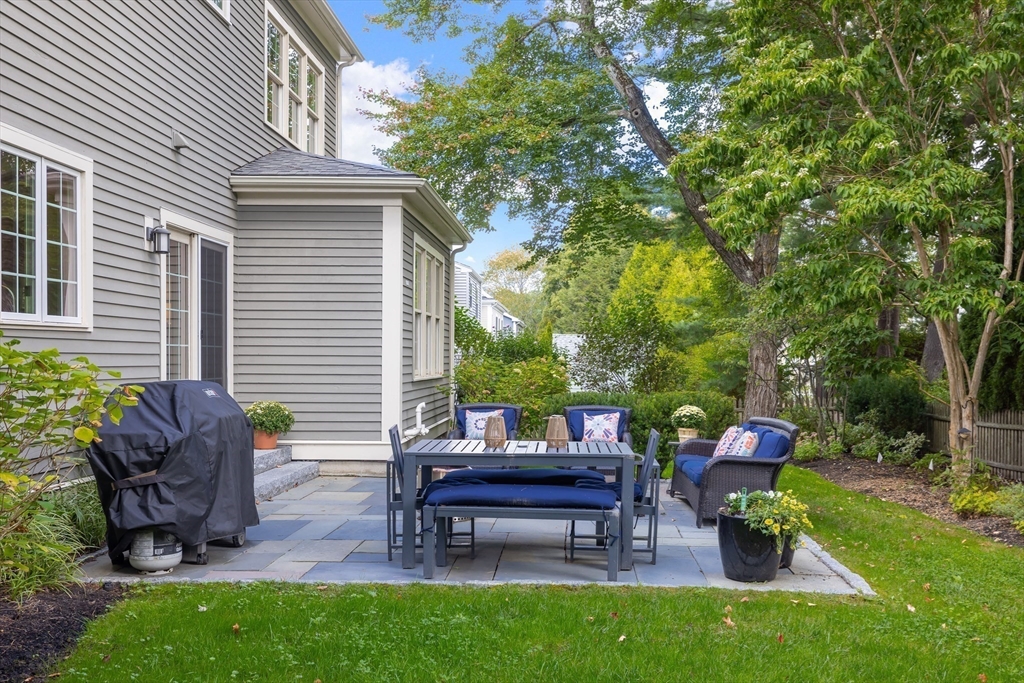 80 Emerson Road Needham, MA 02492 - Photo 36 of 41 a backyard of a house with table and chairs