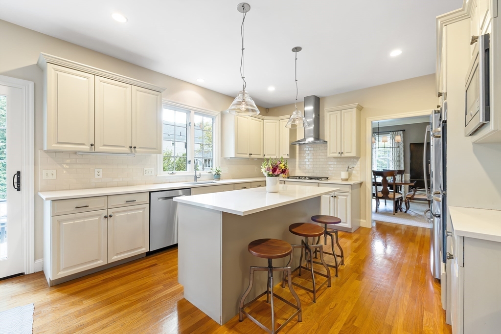 80 Emerson Road Needham, MA 02492 - Photo 6 of 41 a kitchen with a sink a window and chairs
