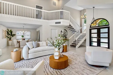 a living room with furniture flowerpot and a rug
