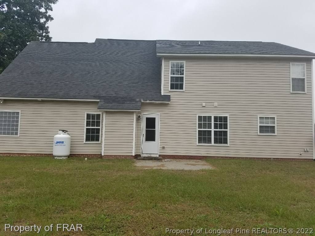6715 Valley Falls Road Hope Mills, NC 28348 - Photo 2 of 13 a house that has a wooden fence in front of it