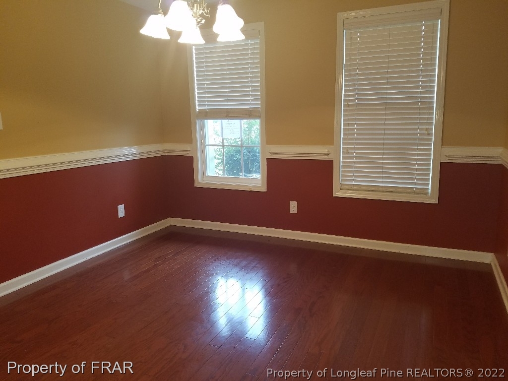 6715 Valley Falls Road Hope Mills, NC 28348 - Photo 5 of 13 an empty room with wooden floor and windows