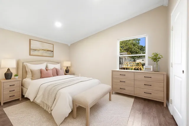 a bedroom with a bed and a window