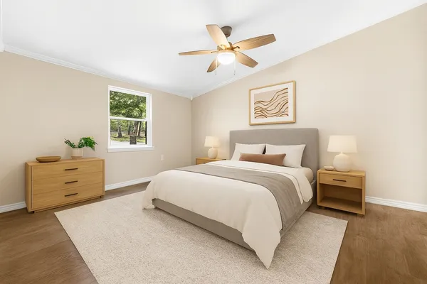 a bedroom with a bed and a window