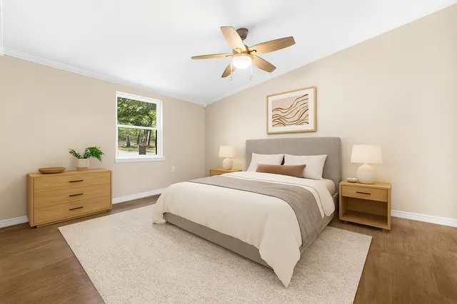 a bedroom with a bed and a window